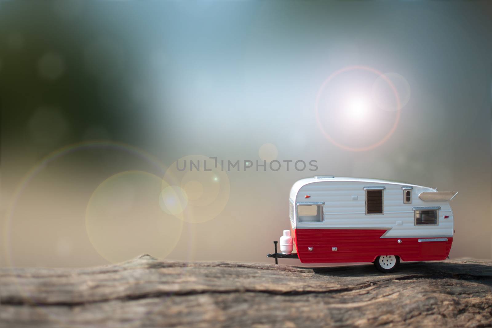 Miniature camper van trailer in the summer countryside 