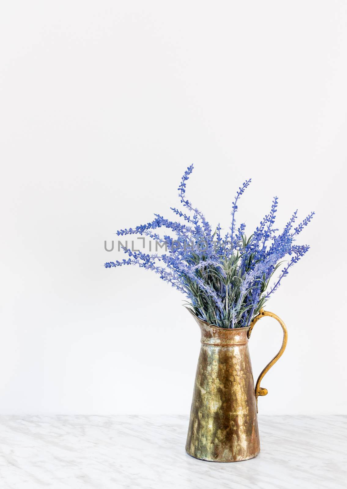 Blue lavender in antique metal jar by anikasalsera