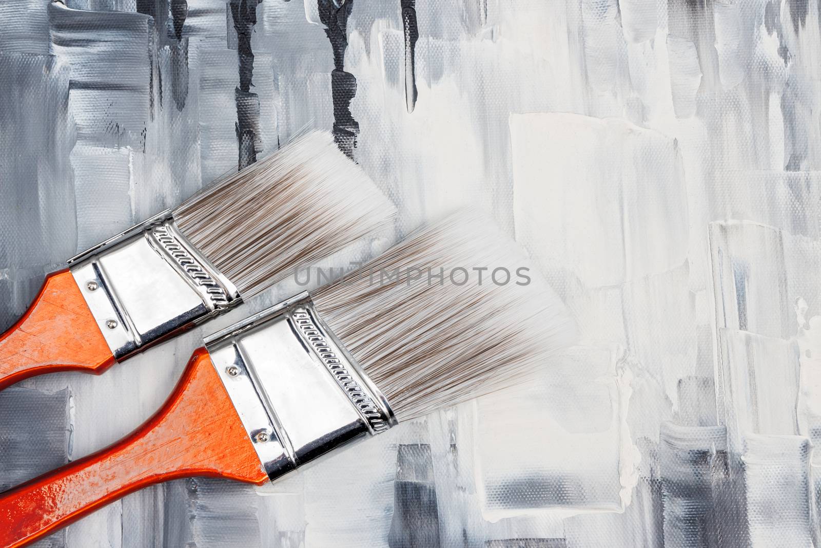 Two paint brushes on artistic canvas by anikasalsera