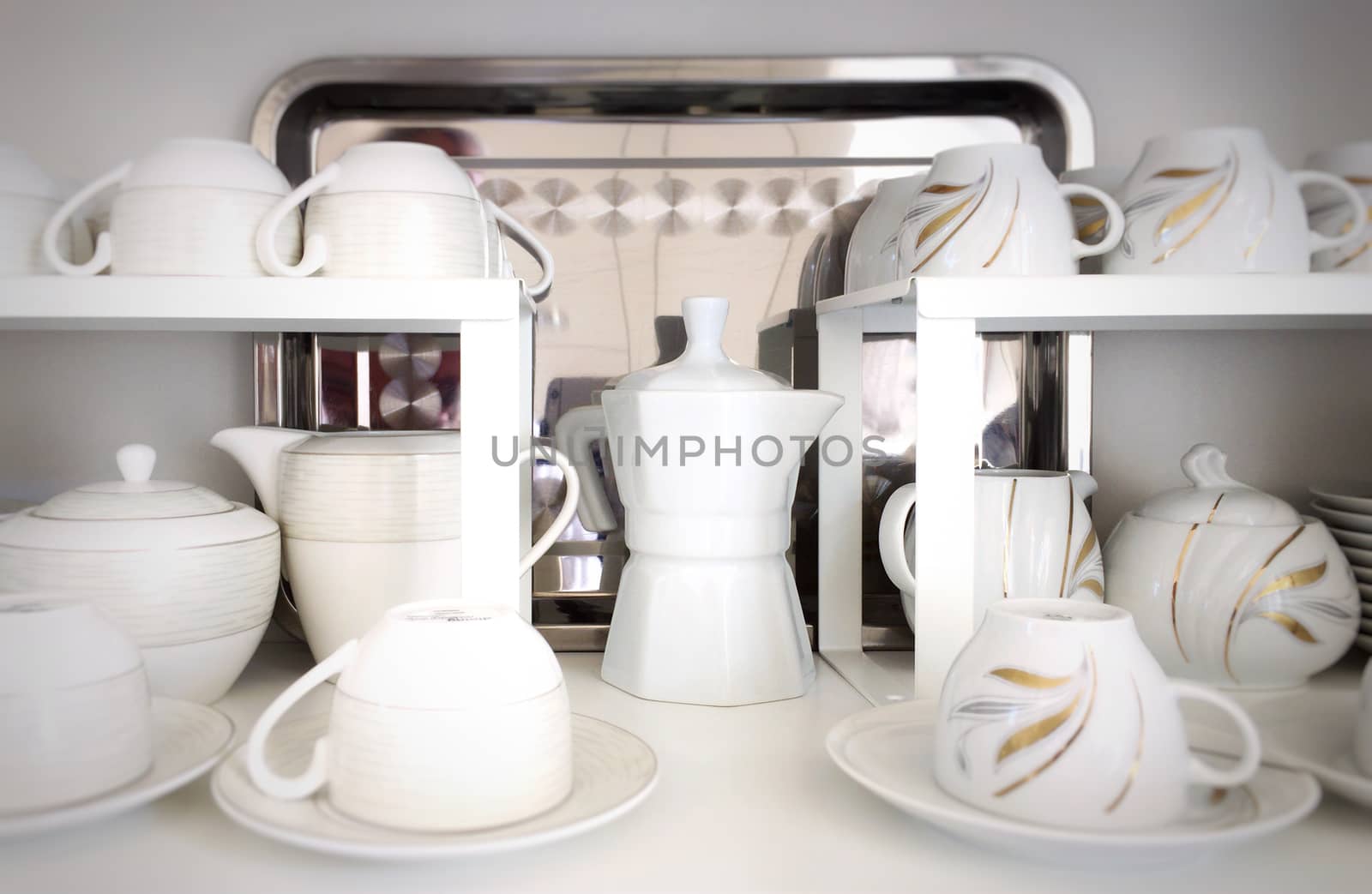 Cups on the white shelves in the store