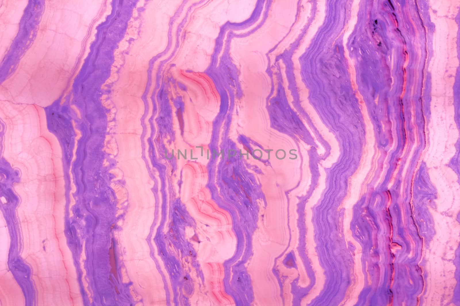 Natural stone background pattern of multicolored stripes purple pink