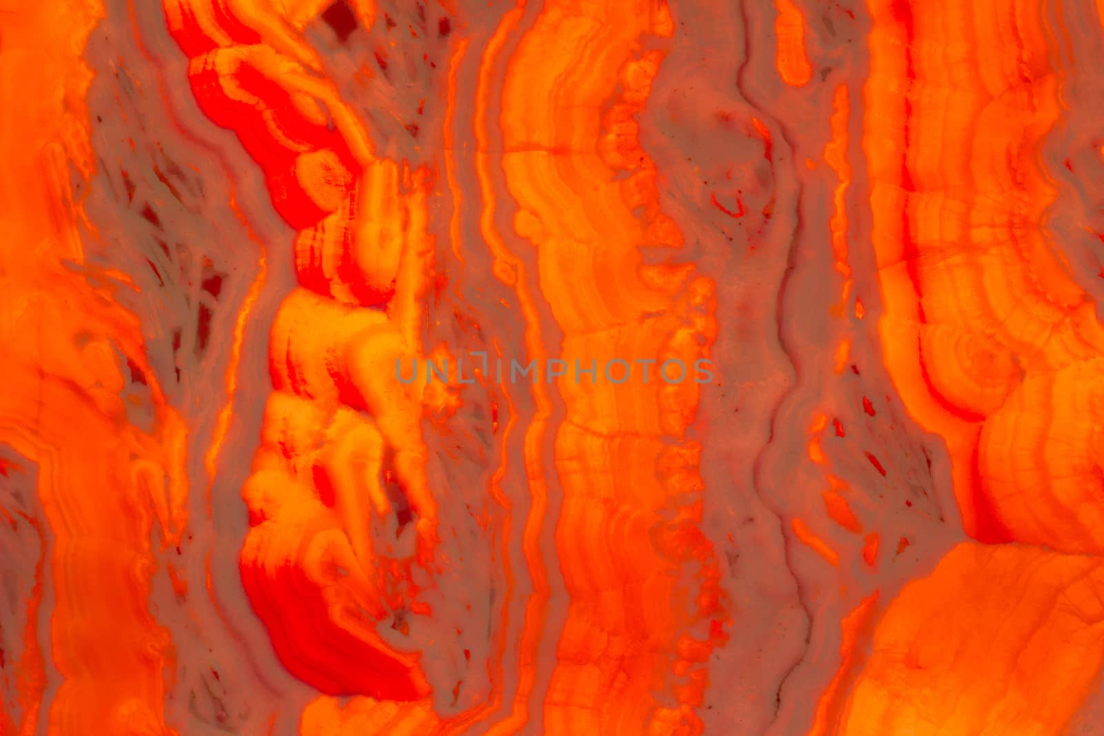 Natural stone glass background of multicolored stripes red orange hot