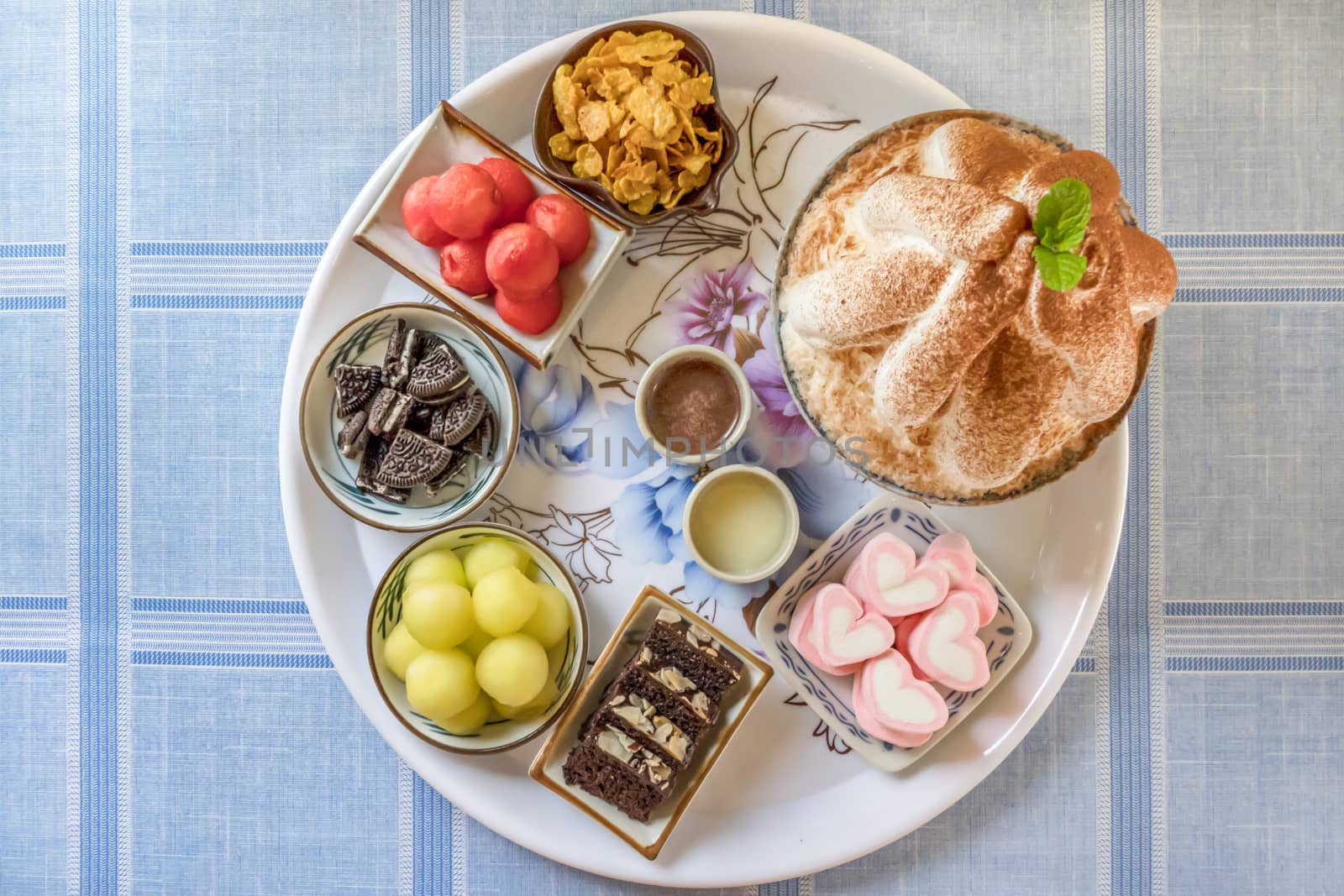 top view of Bingsu on tray served with mix  sweet topping , fruits and baked