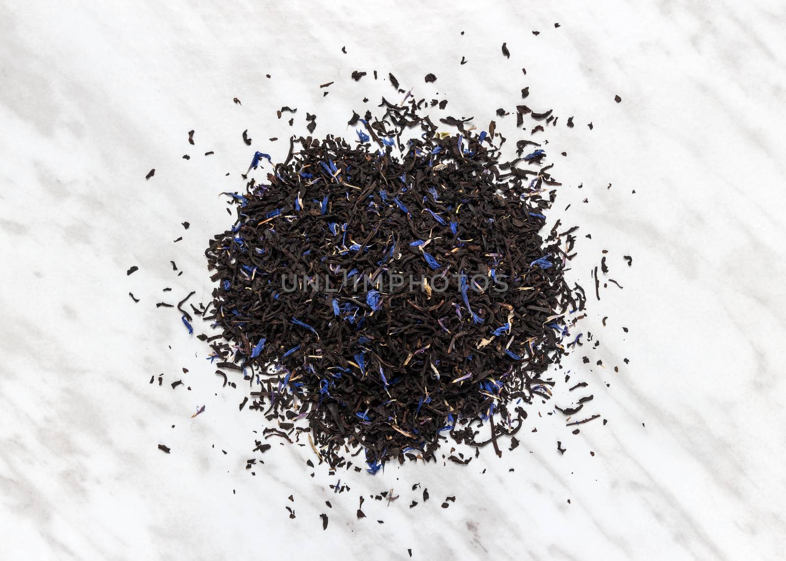 High quality black Earl gray tea leaves on marble background.