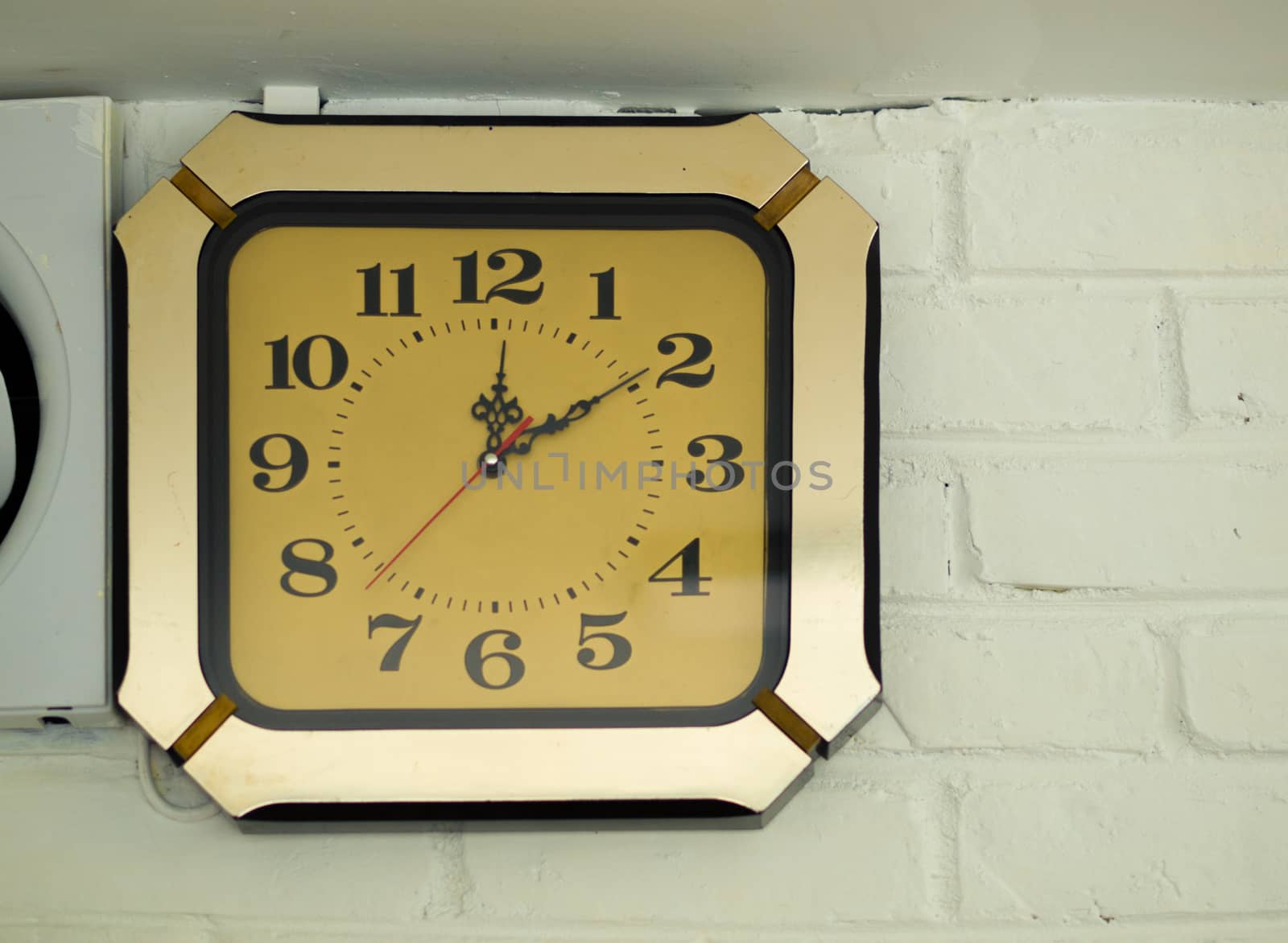 COLOR PHOTO OF ANTIQUE CLOCK MOUNTED ON WALL