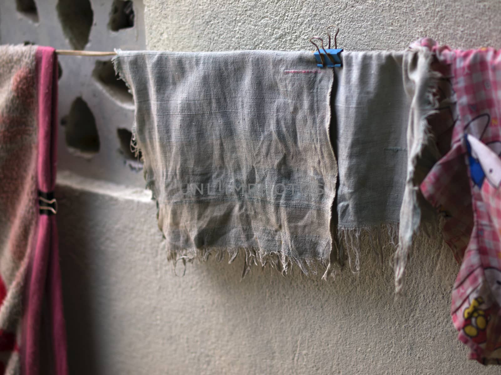 COLOR PHOTO OF OLD AND FADED HANDKERCHIEF DRYING OUTSIDE