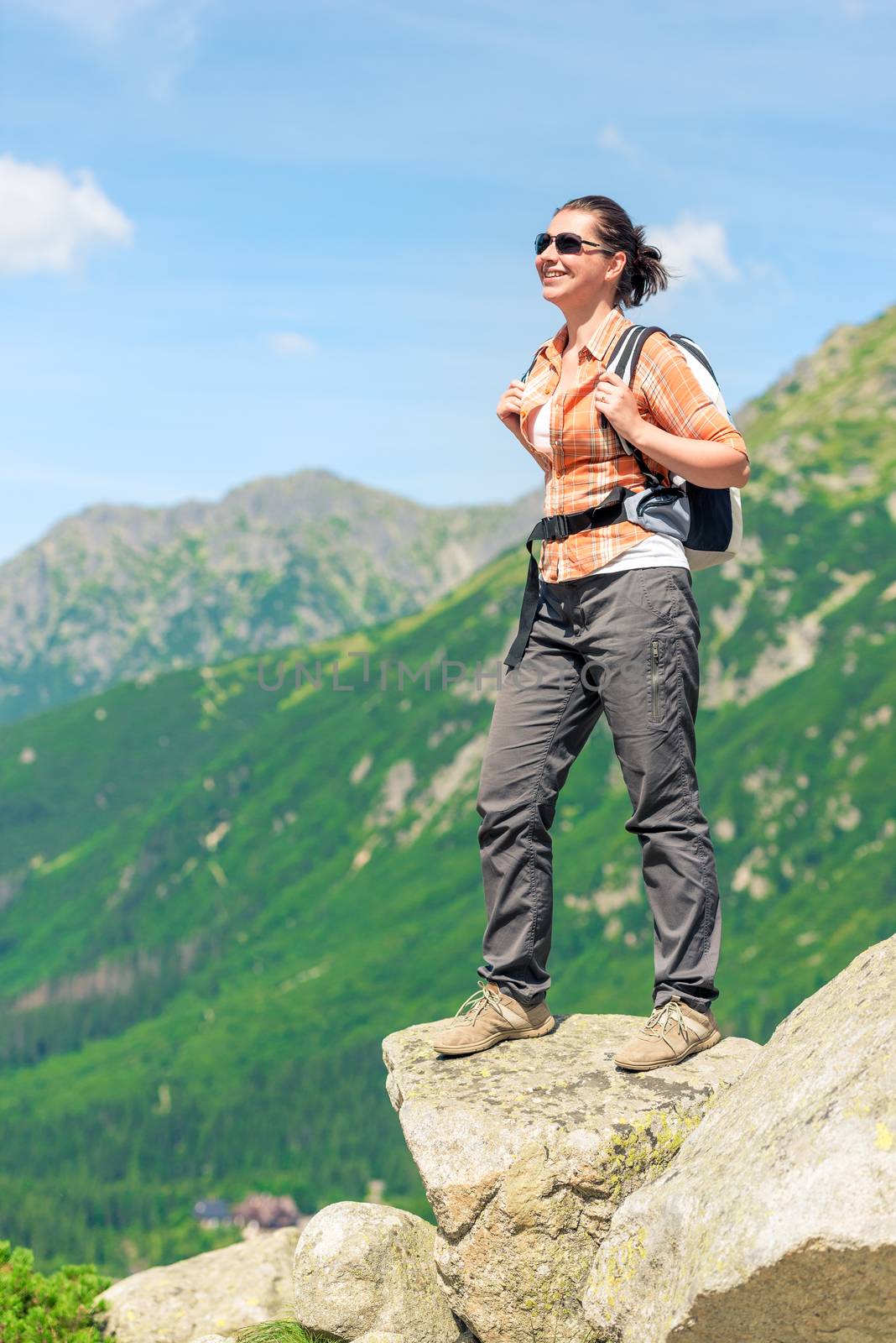a tourist who conquers a high mountain with a backpack enjoys freedom