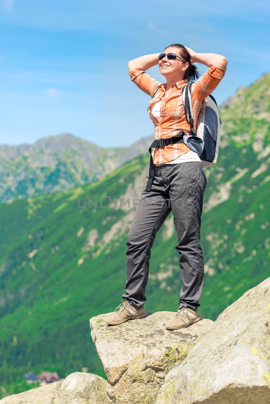 happy tourist on a sunny day in the mountains on a hike enjoying by kosmsos111