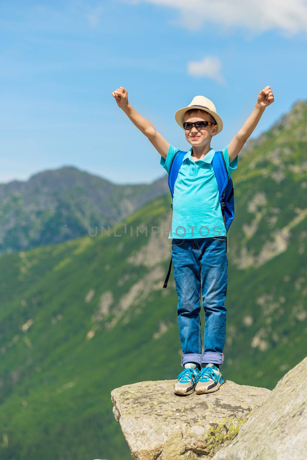 traveler boy enjoys the beauty of the mountains and freedom