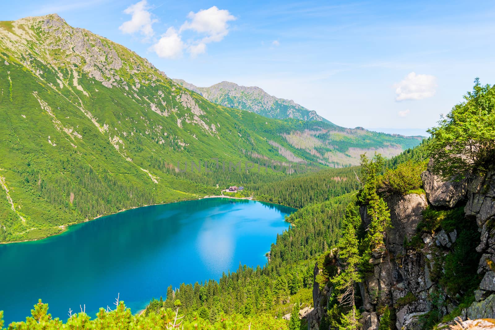 beautiful scenic Lake Morskie Oko on a sunny summer day, view from the mountain