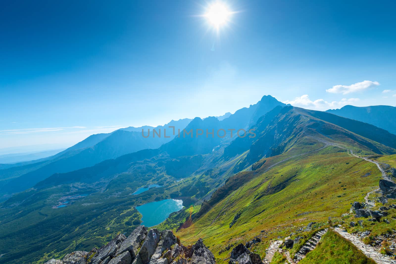 The bright sun in the sky over the top of Kasprowy Wierch, Poland