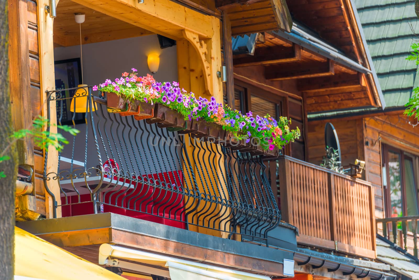 balcony of a wooden house close-up decorated with flower pots