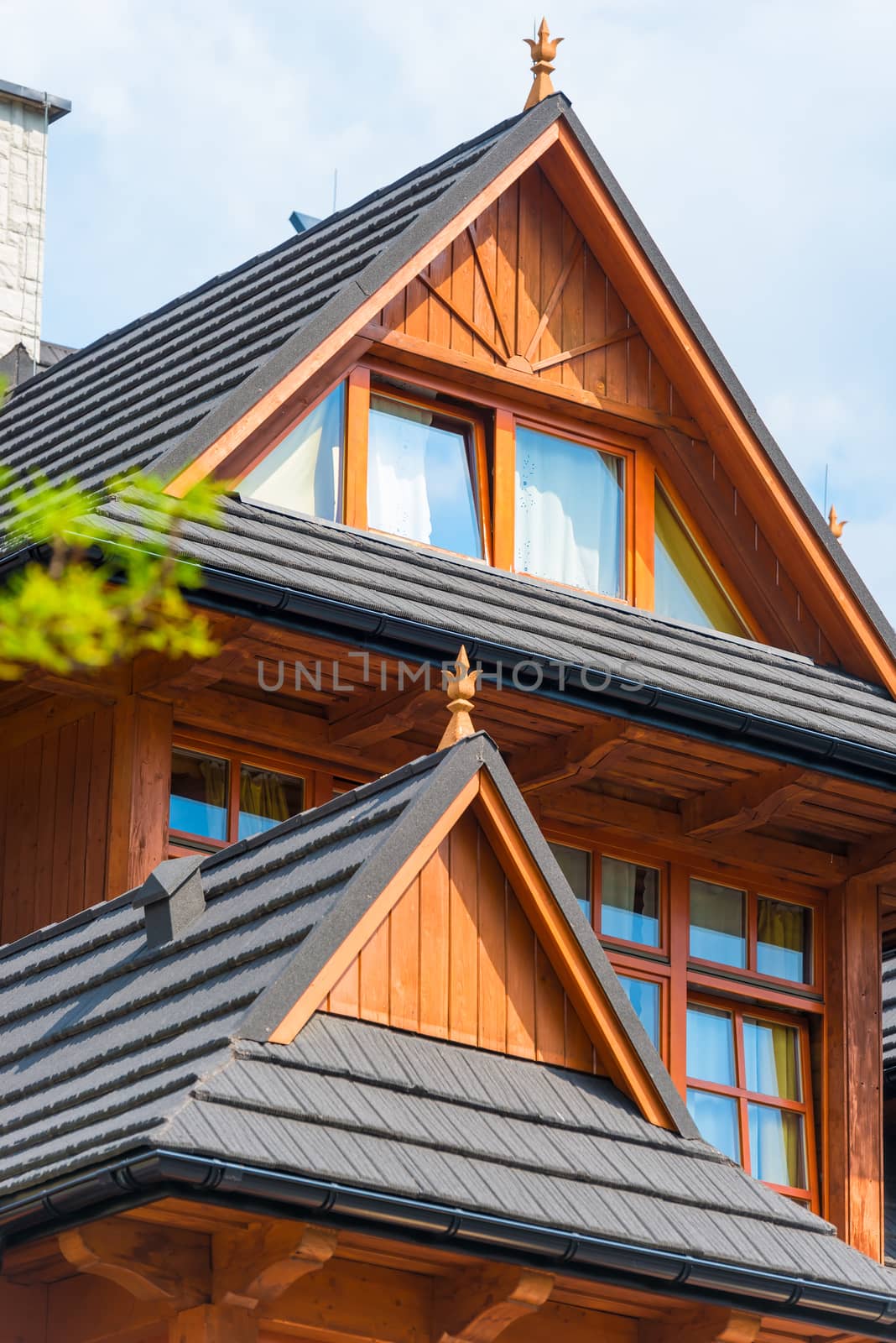 architectural elements of a wooden house against a blue sky