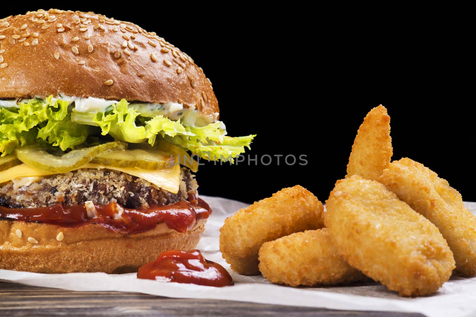 Craft beef burger and french fries on wooden table