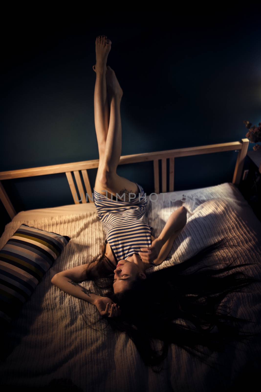 Young attractive woman on a bed by kzen