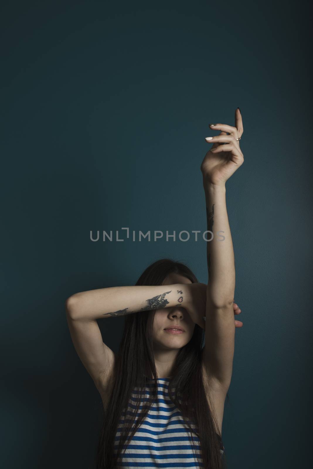 Young attractive woman on dark blue wall background