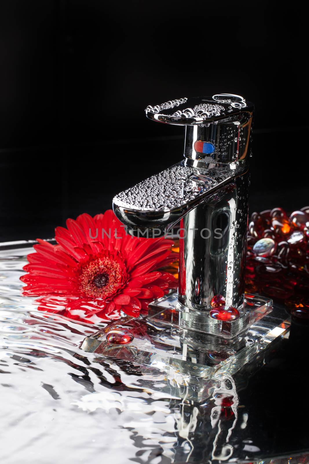 Metal chromium-plated mixer for wwater on a studio background