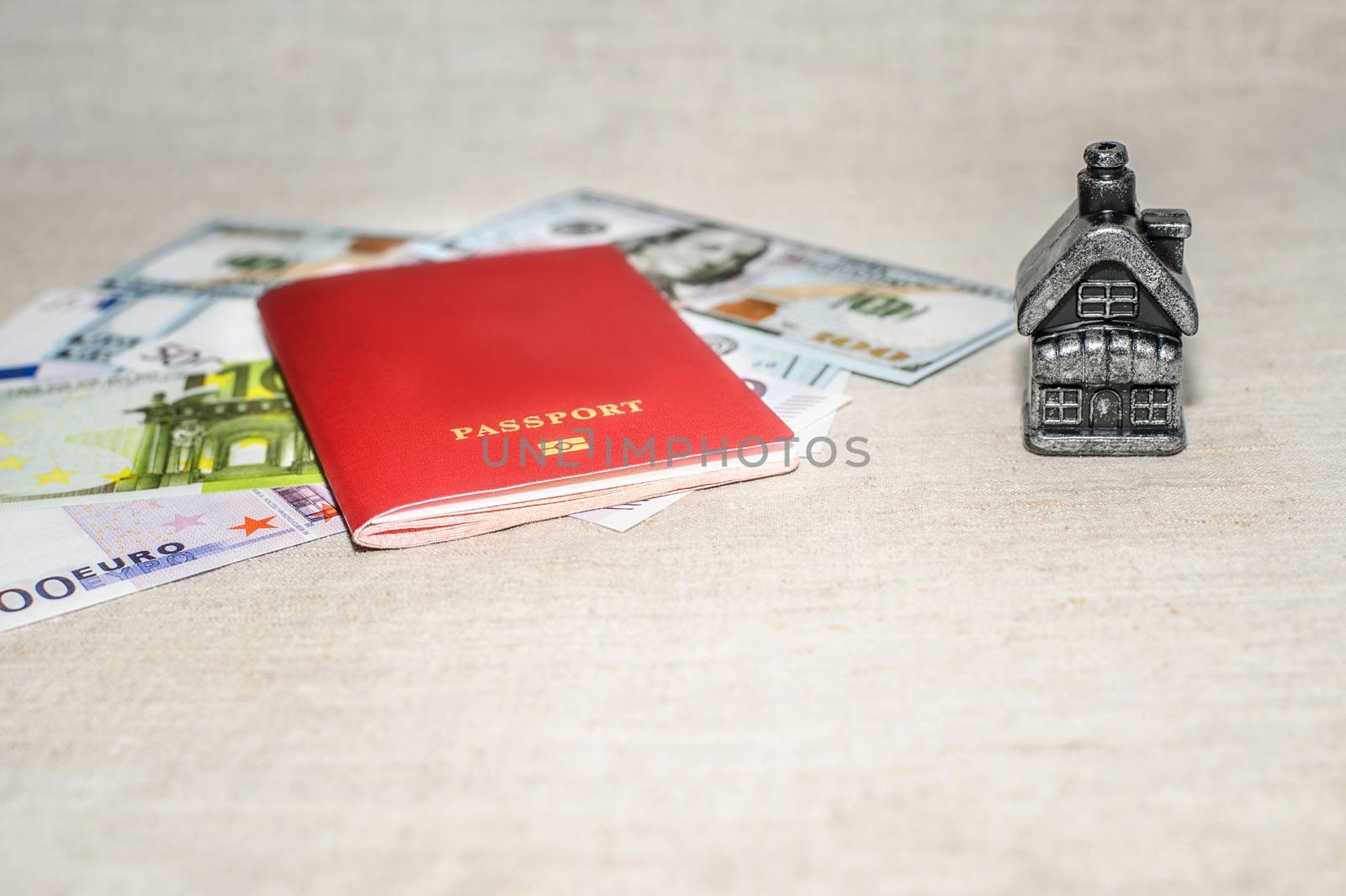 Passport, money and home - the concept of buying a property.