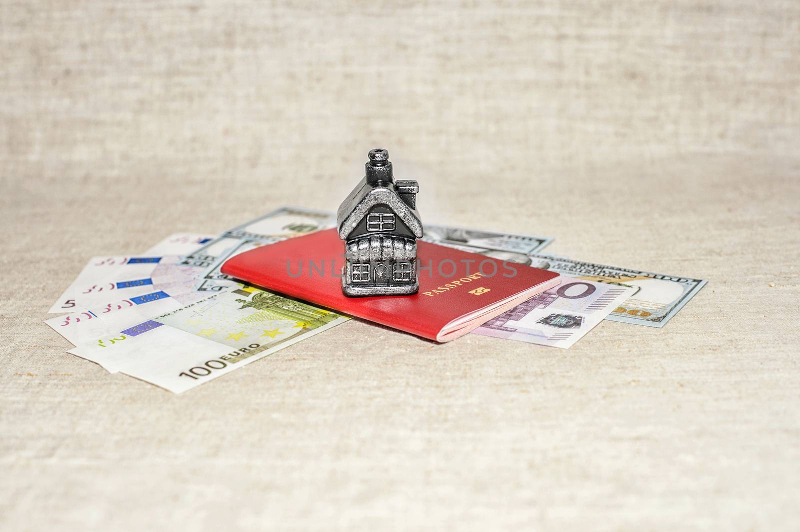 Passport, money and home - the concept of buying a property.