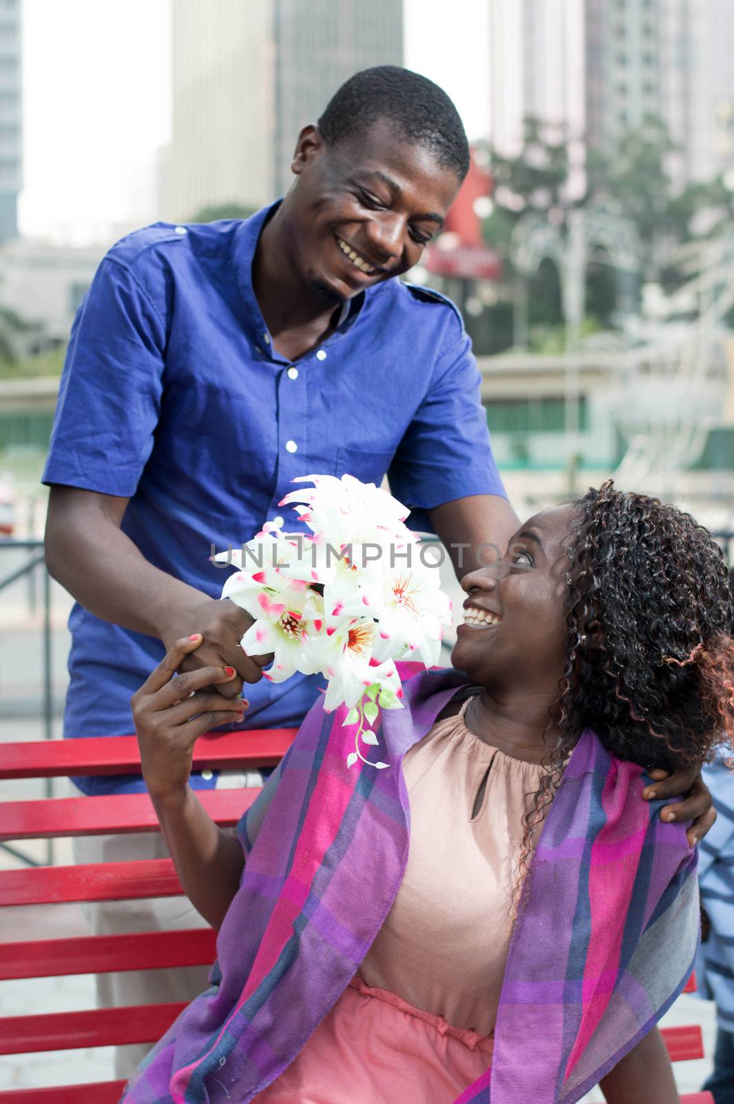 man made a surprise to his beloved by offering her flowers.