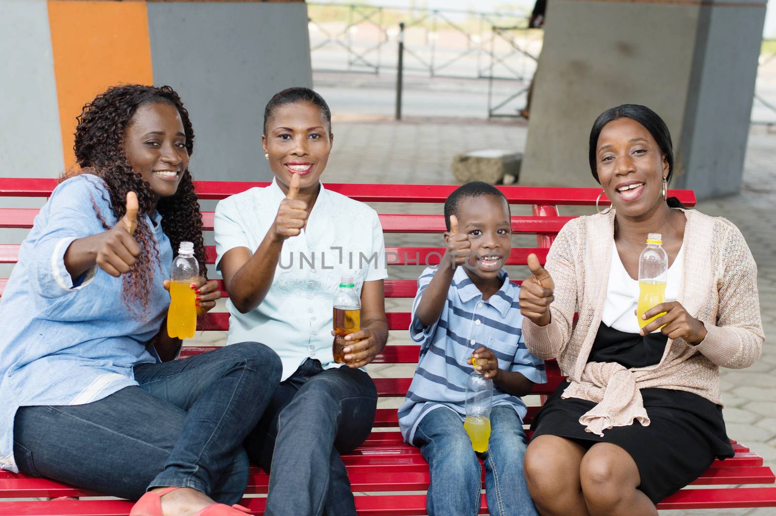These young woman and little boy sitting on a bench.