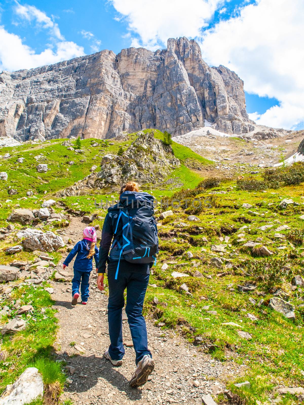 Mother and her daughter hiking in the mountains. Travellig adventre and active vacation with children. Dolomites, Italy by pyty