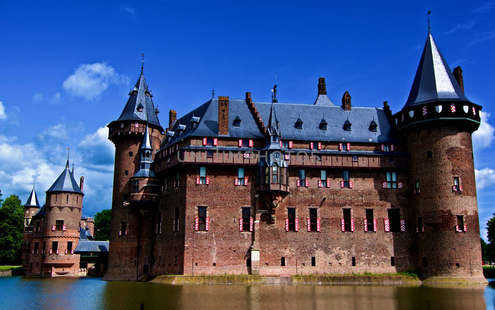 Medieval Castle De Haar from side of Moat against Blue Sky Outdoors. Utrecht, Netherlands