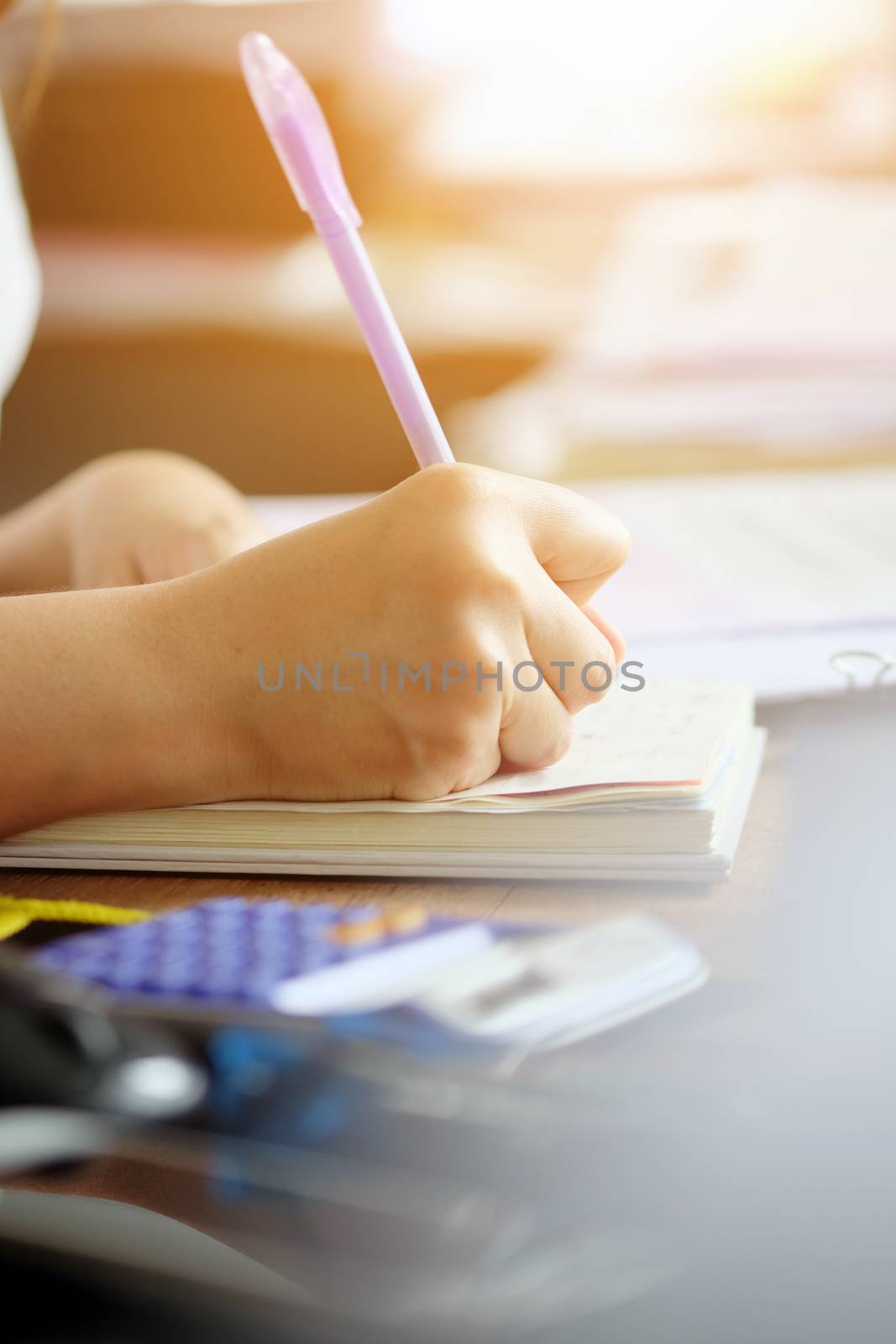 close up female hands of accountant with calculator and pen. business accounting background.