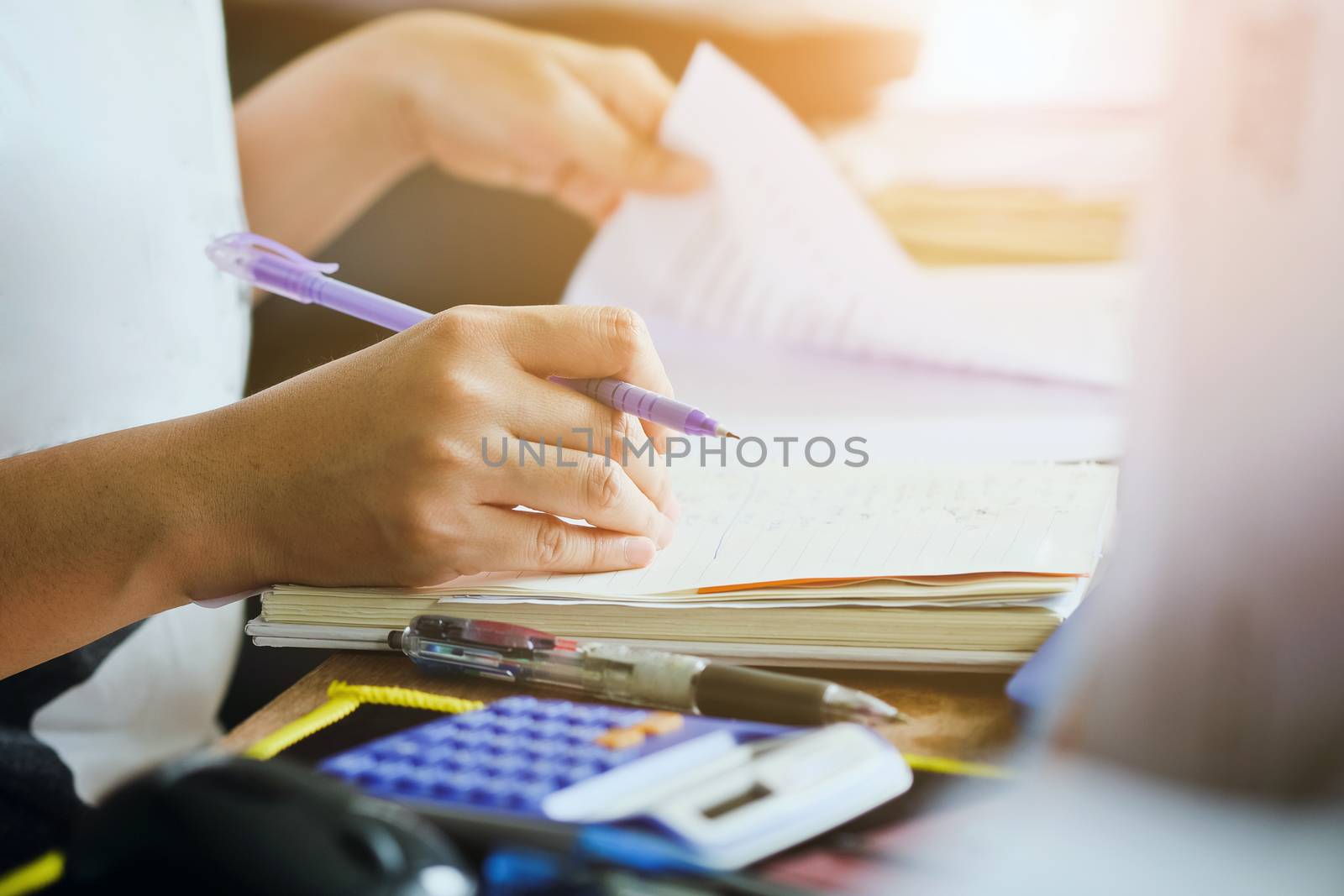 close up female hands of accountant with calculator and pen. business accounting background.