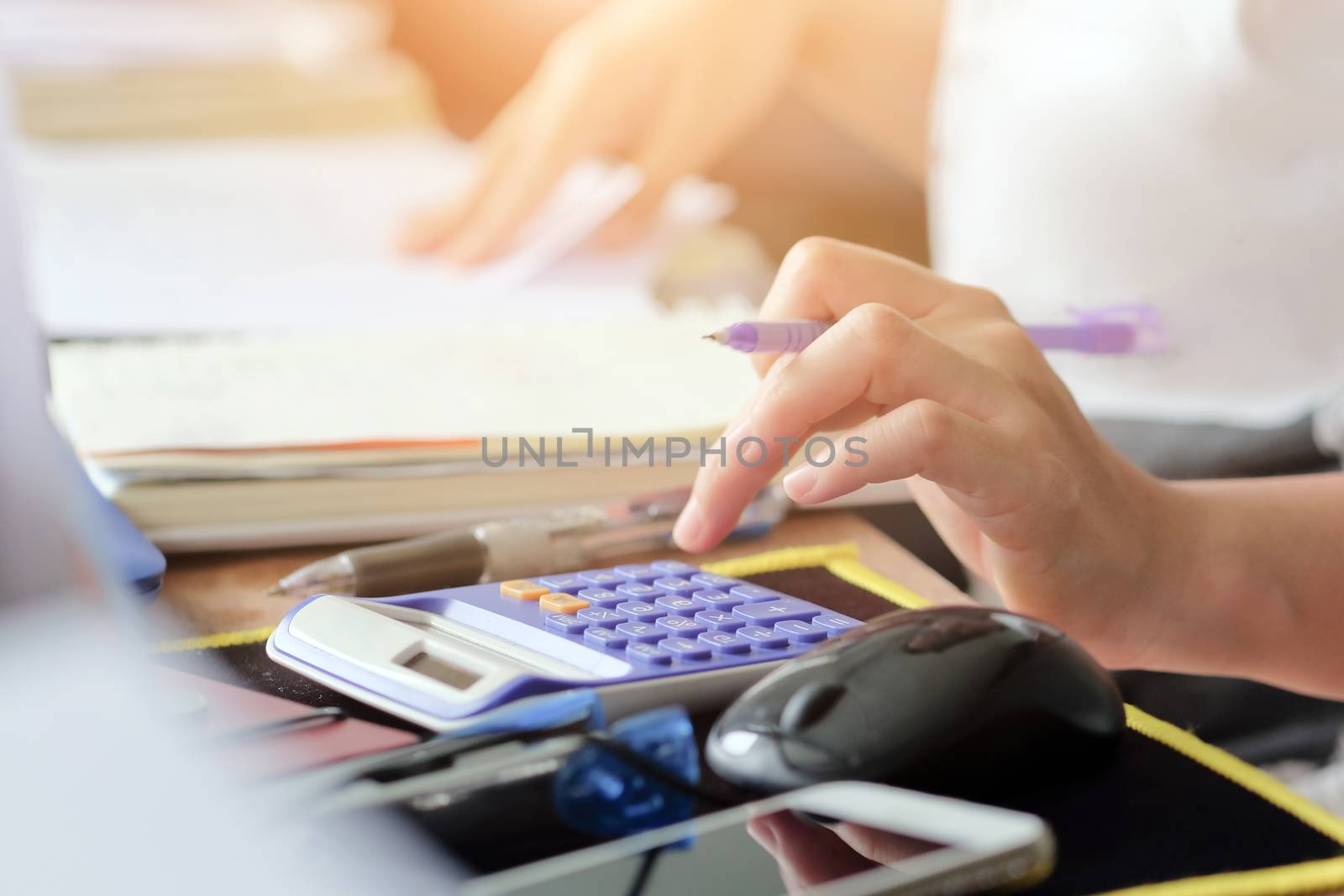 close up female hands of accountant with calculator and pen. business accounting background.