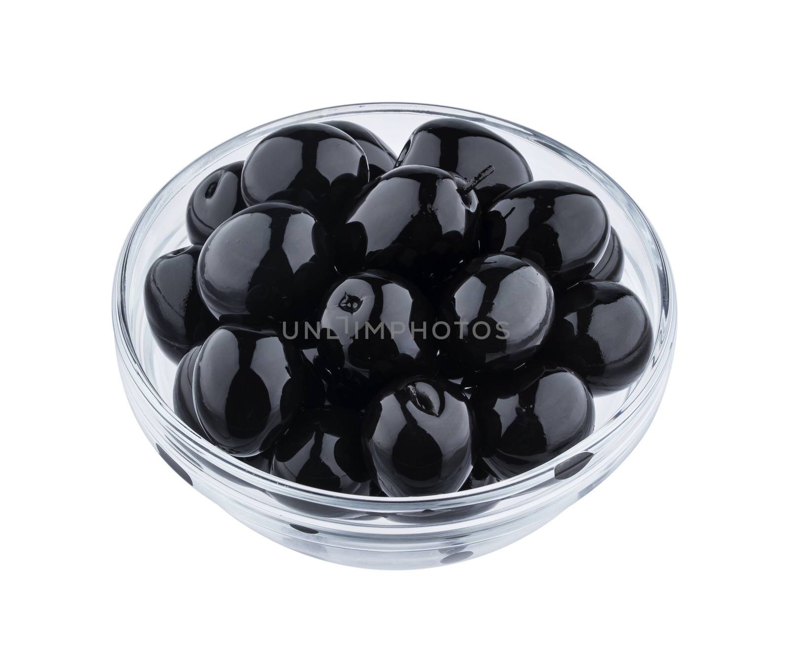 Heap of black olives in glass bowl isolated on white background with clipping path, close up