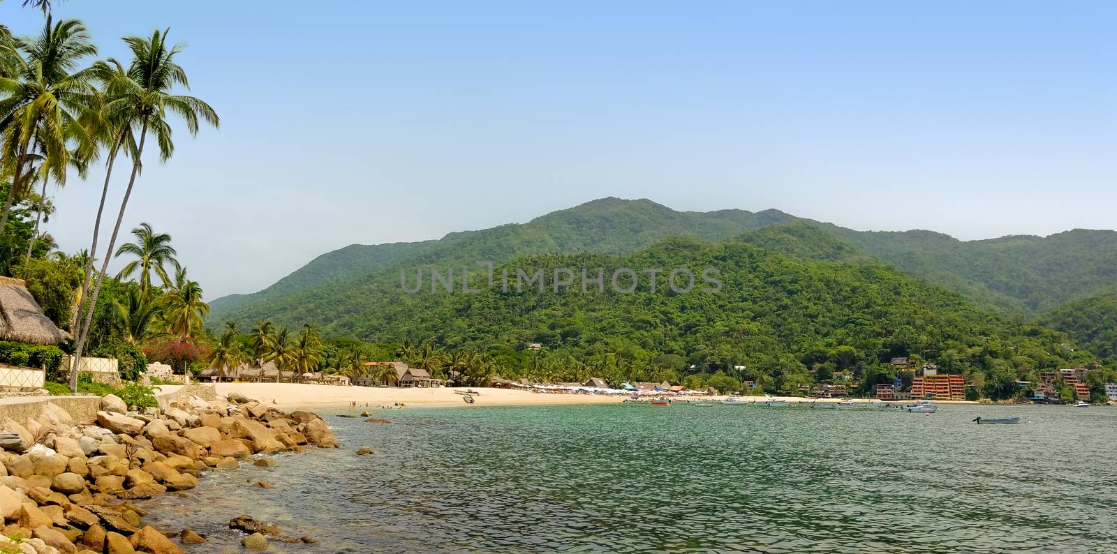 Panorama of Yelapa Beach on a sunny day, one of the most beautiful beaches near Puerto Vallarta, resort town in Mexico on the Pacific coast, in the state of Jalisco. The image was taken in July.