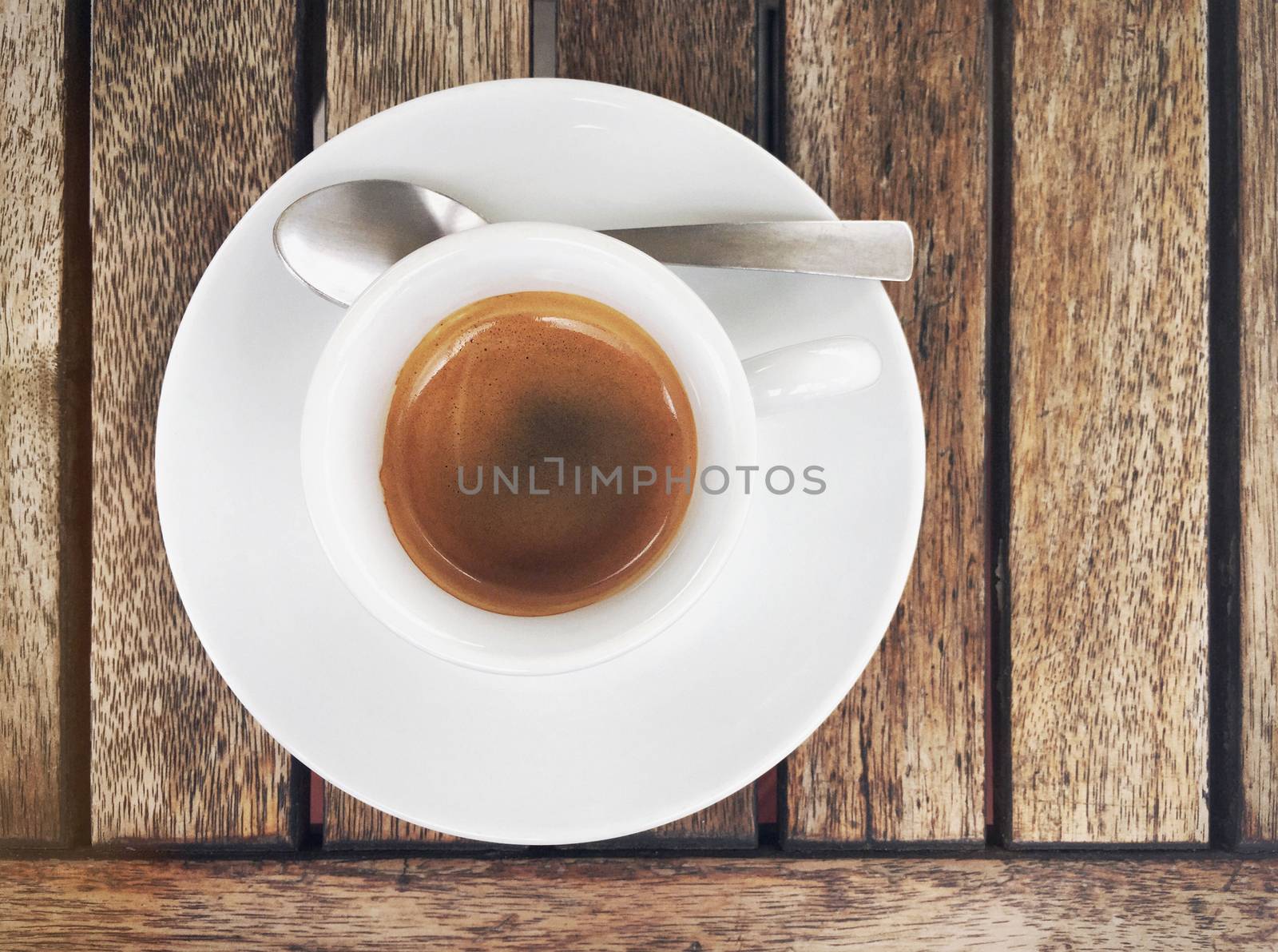 Top view of espresso coffee in white cup on wood table. 