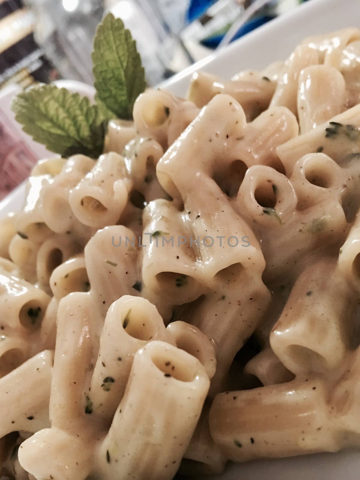 Delicious and fresh pasta with sauce, broccoli and chives.