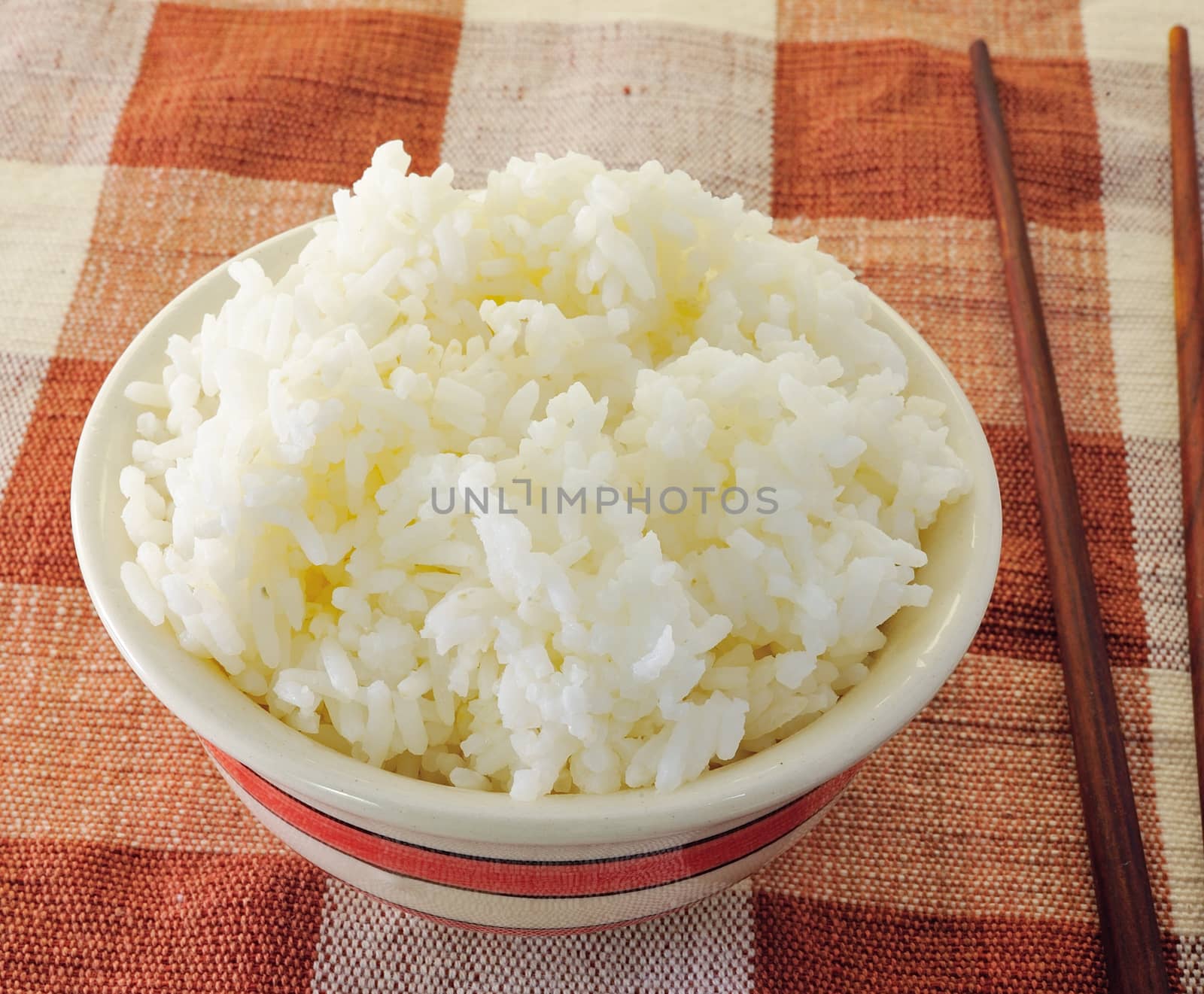 Rice in a bowl on a white background by sommai