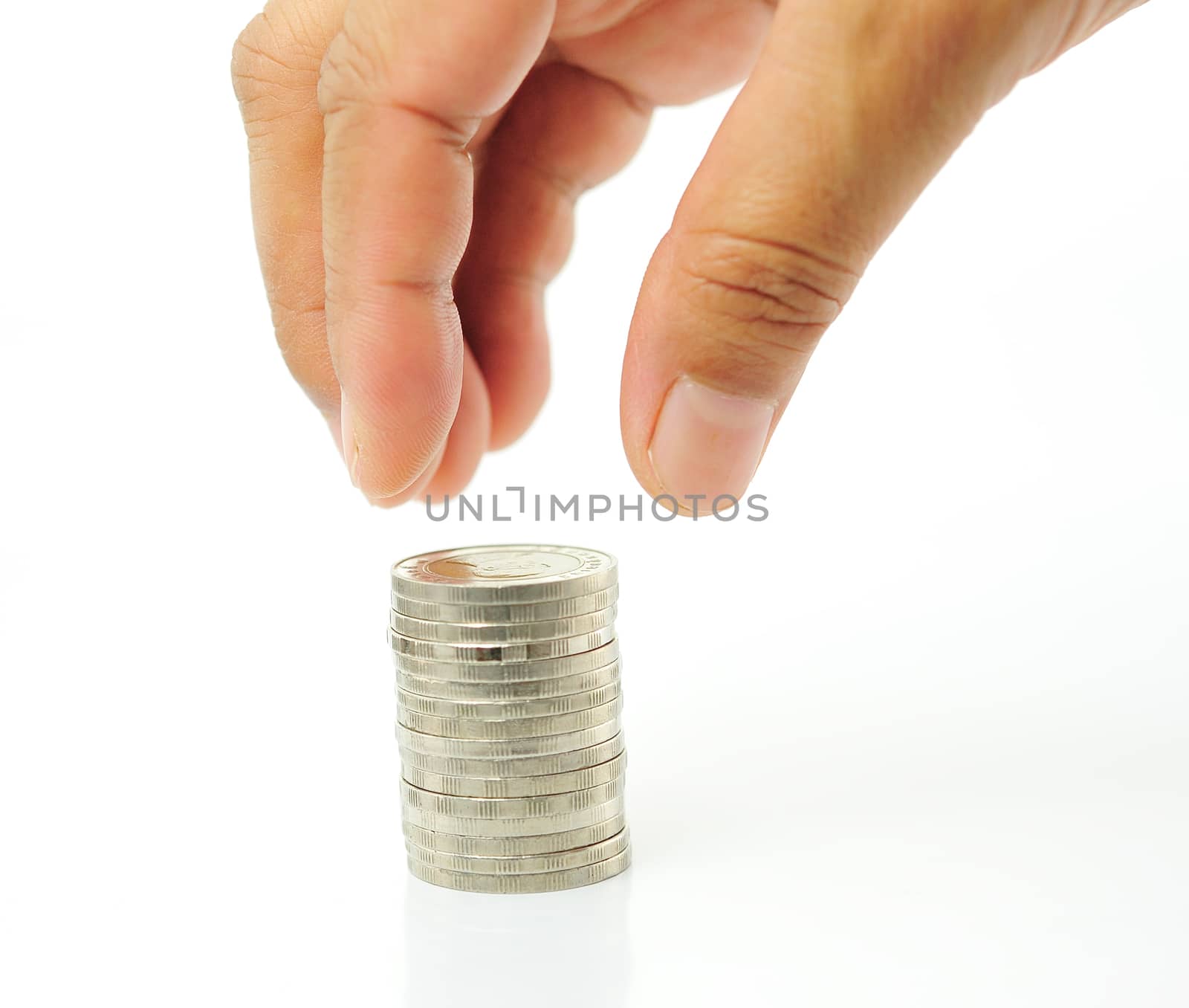 Finger put coin on coin-stack