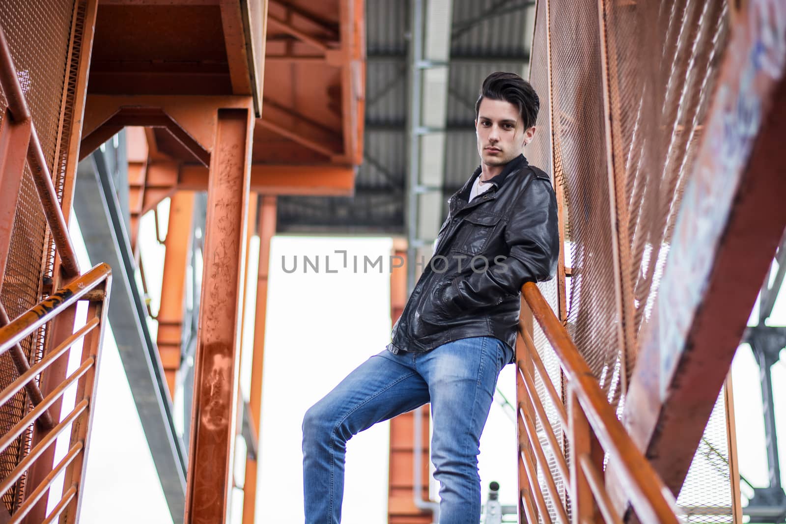Young man standing outdoors in urban setting by artofphoto
