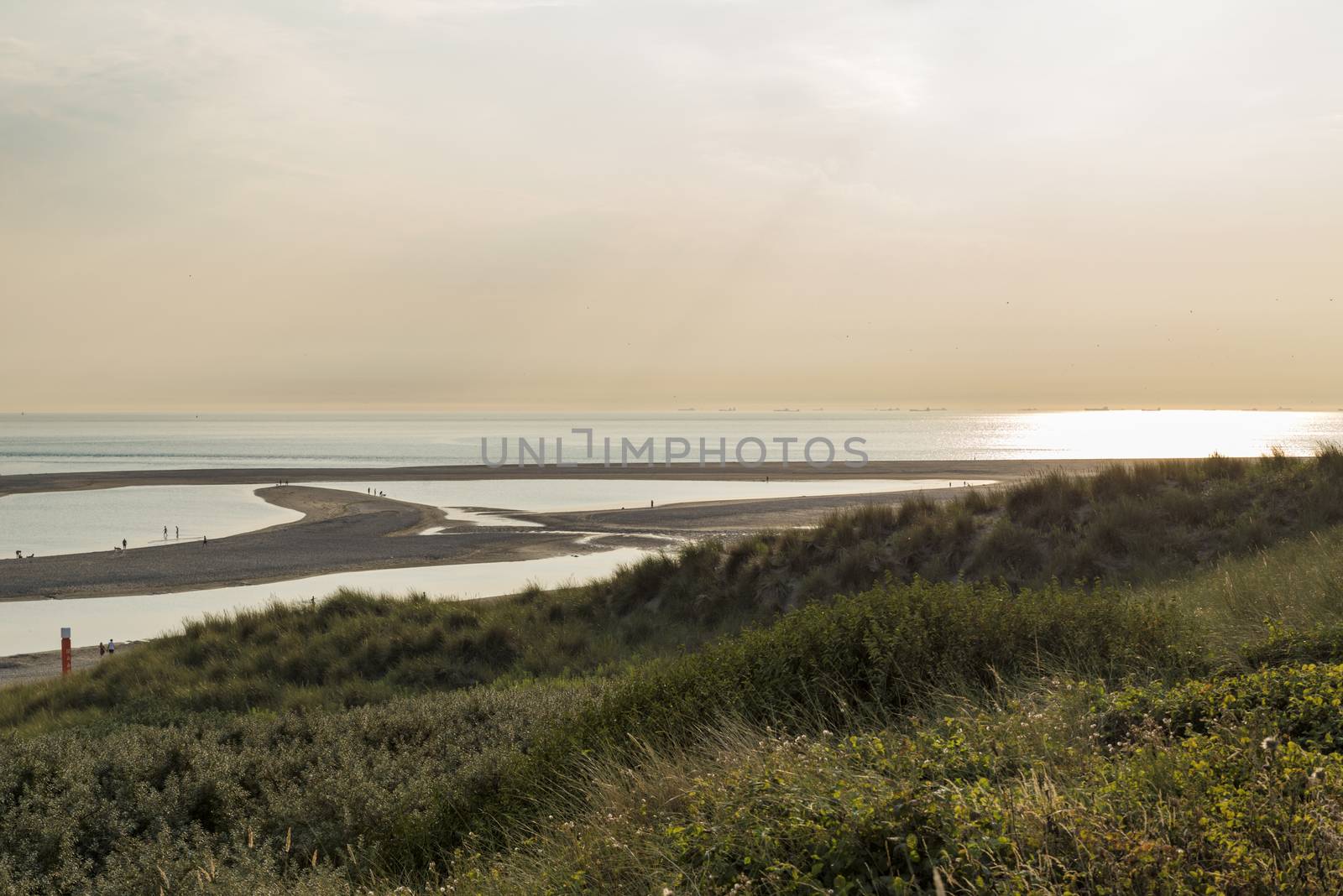 Rotterdam,Holland,16-july-2018:People late at the day waiting for sunset at the Maasvlakte beach, at eight o clock it is still 28 deg celcius this year