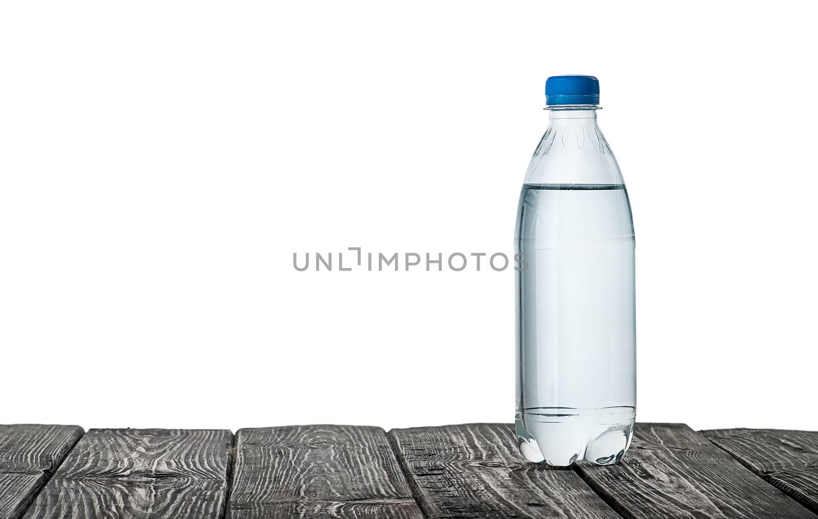 Plastic bottle of water on the table isolated on white background