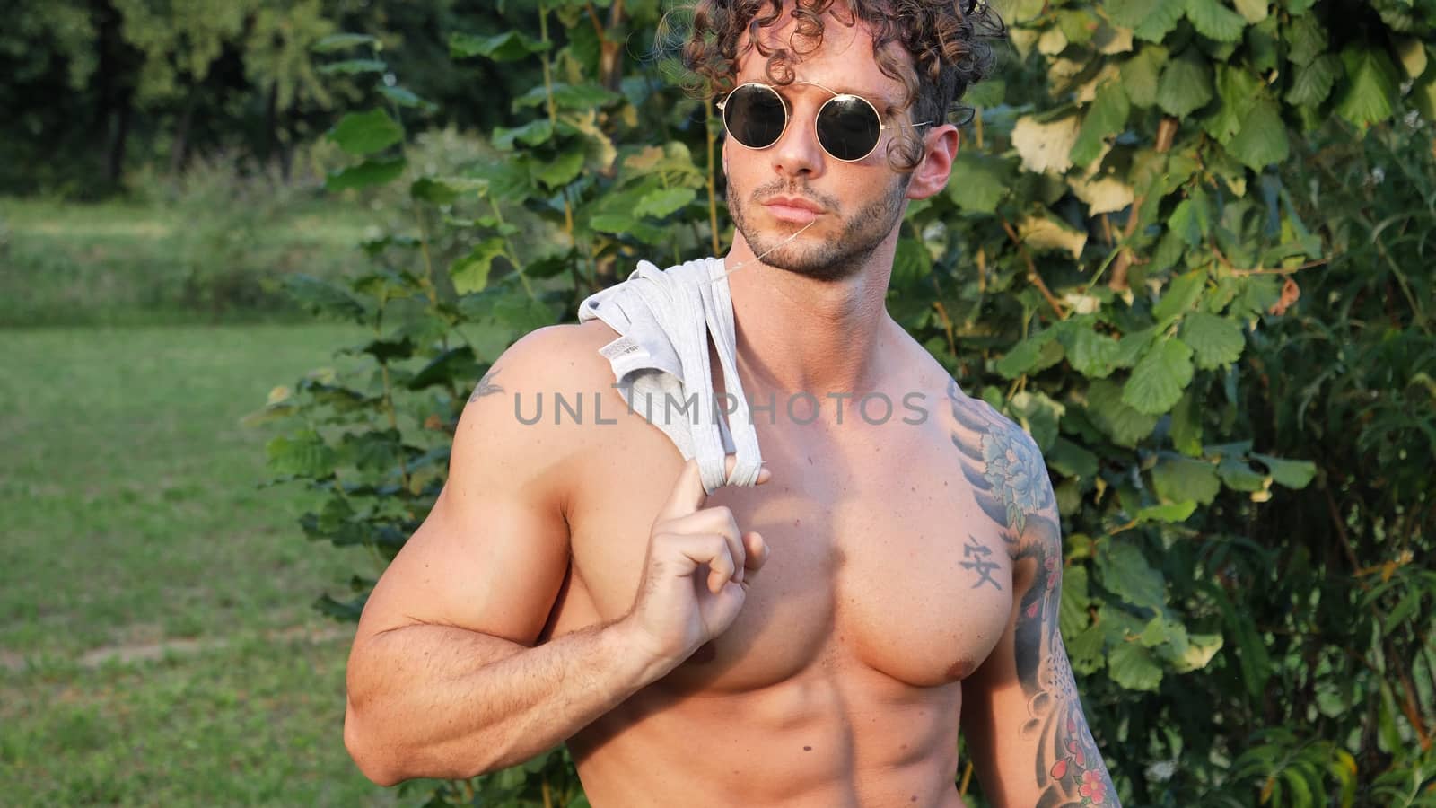 Handsome Muscular Shirtless Hunk Man Outdoor in Country Standing on Grass. Showing Healthy Muscle Body While Looking away