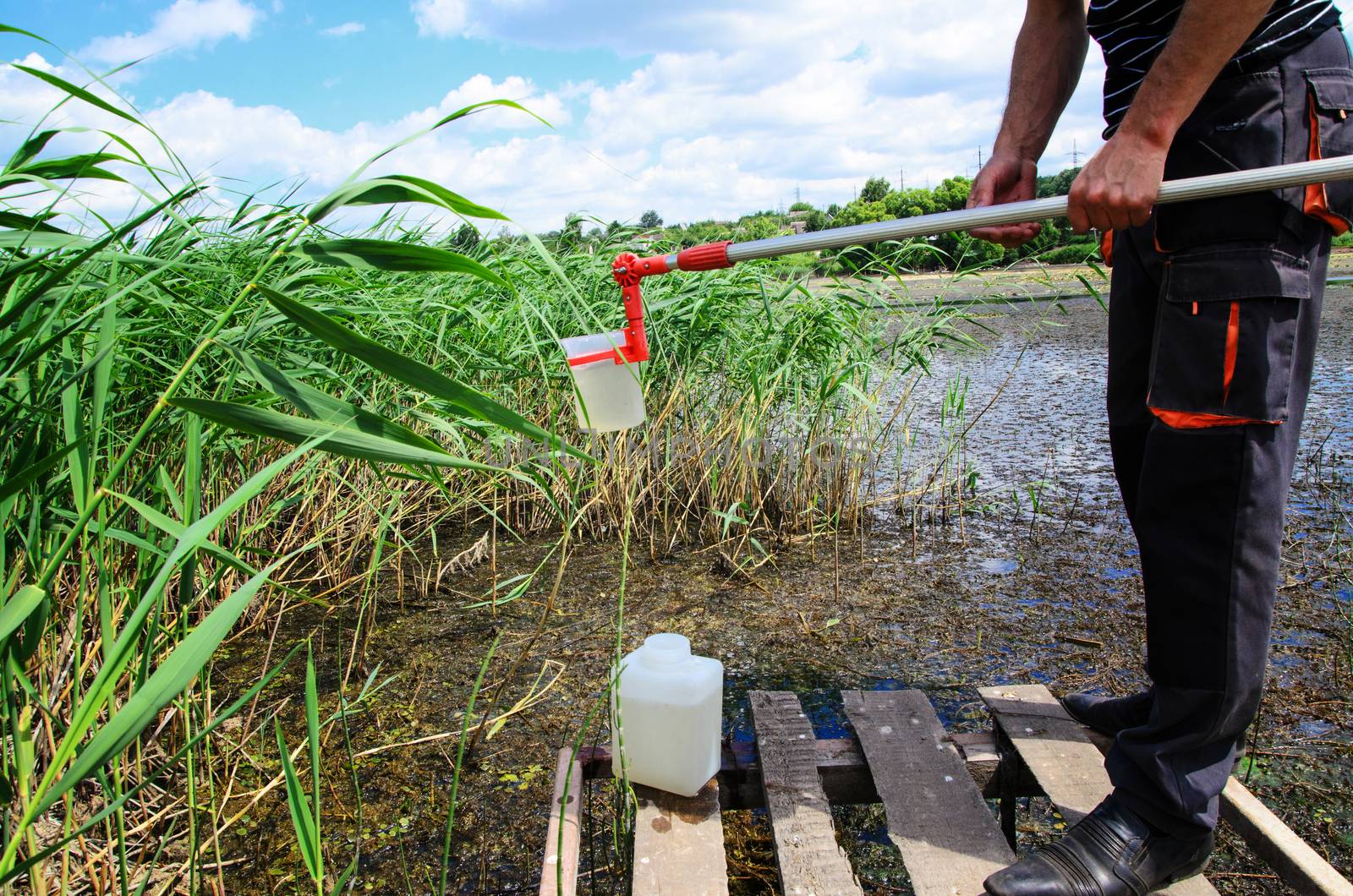 Take samples of water for laboratory testing. The concept - analysis of water purity, environment, ecology