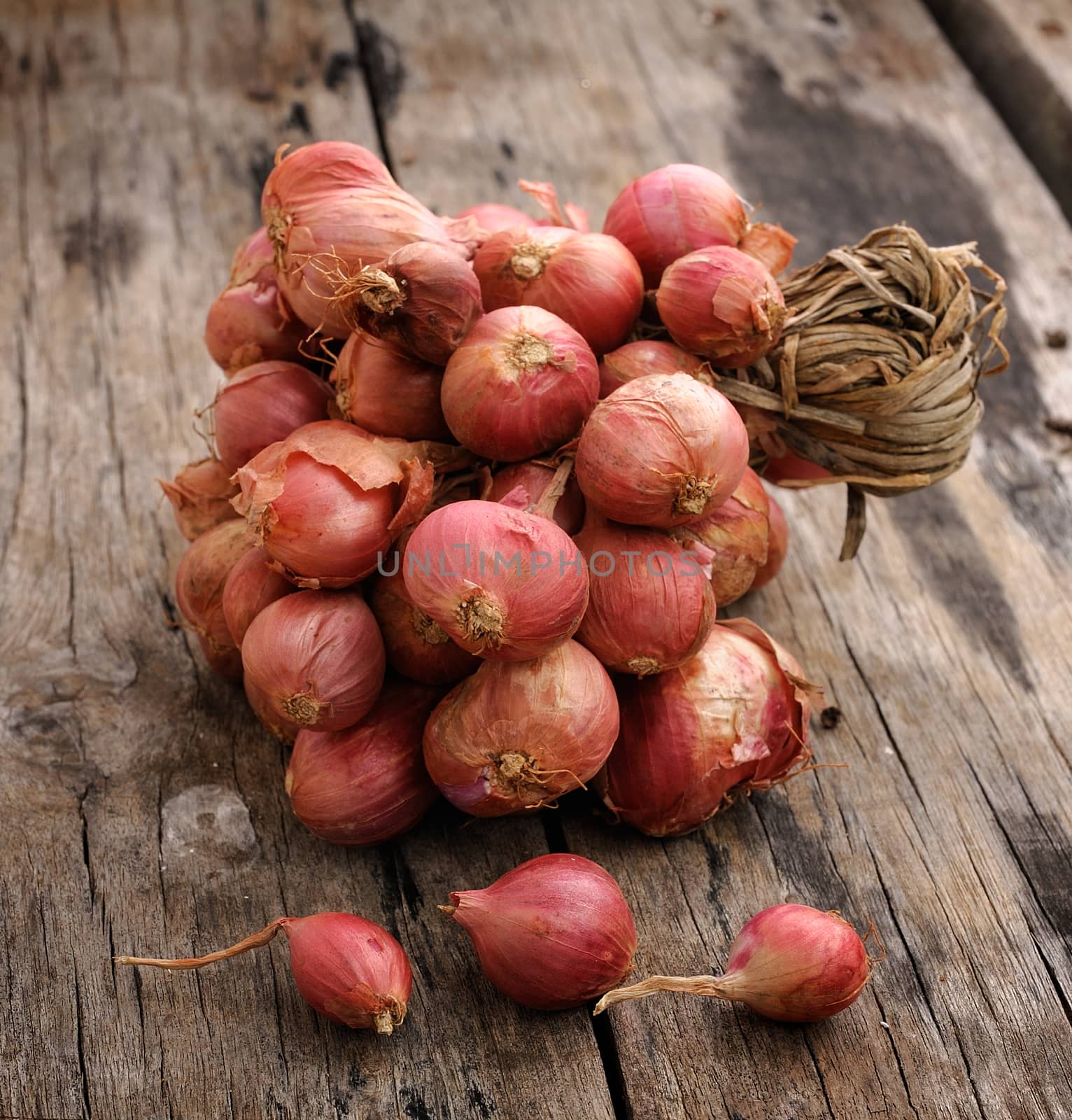 Shallot onions in a group on wood by sommai