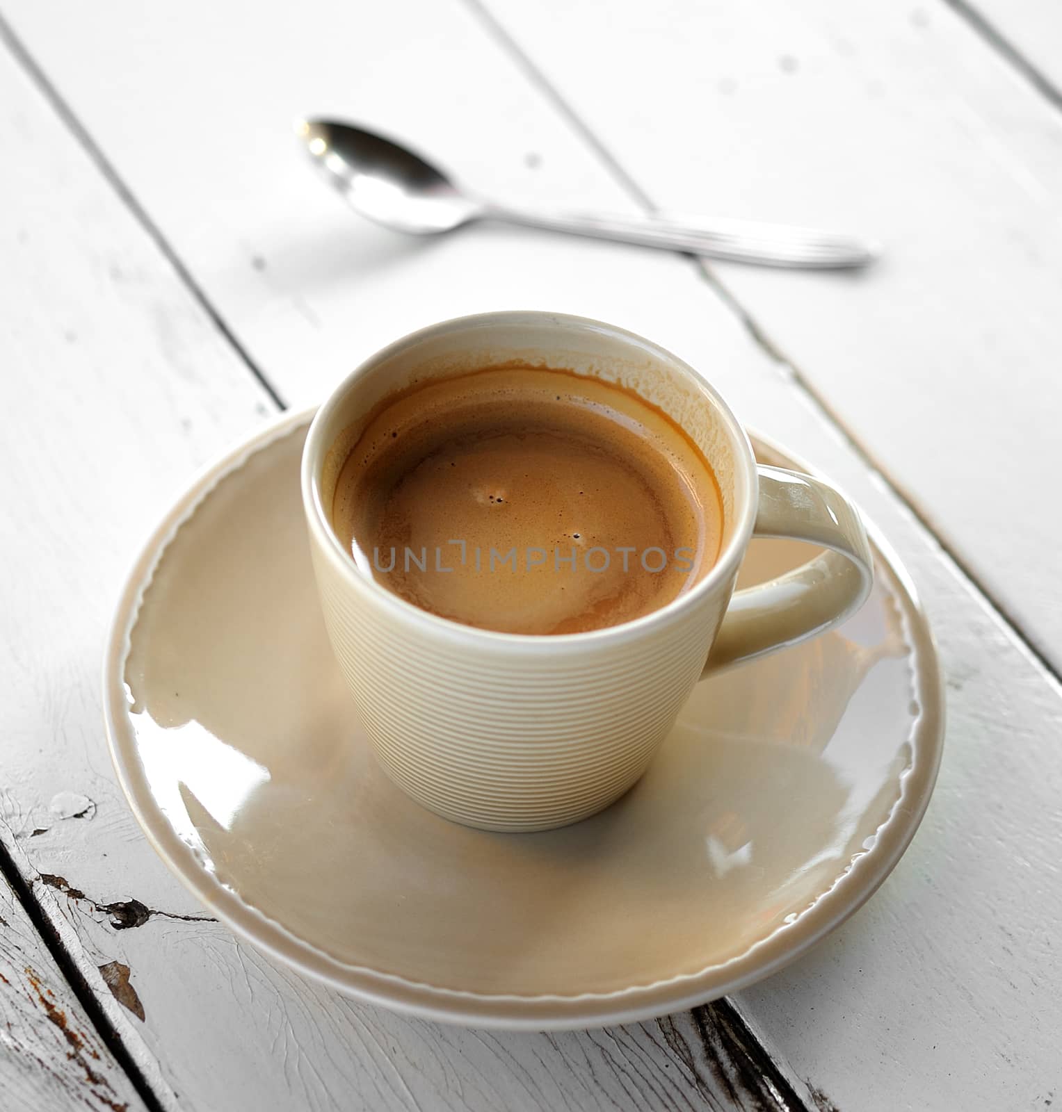 Cup of coffee on a wooden table by sommai