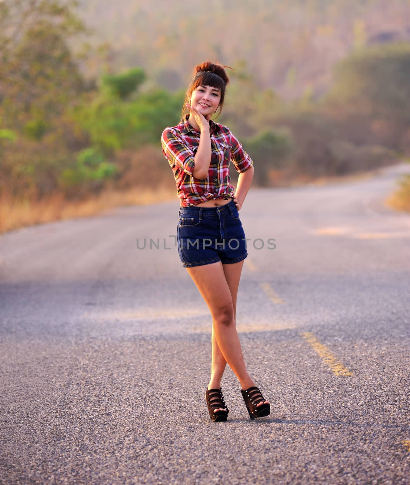 A woman stands at the road