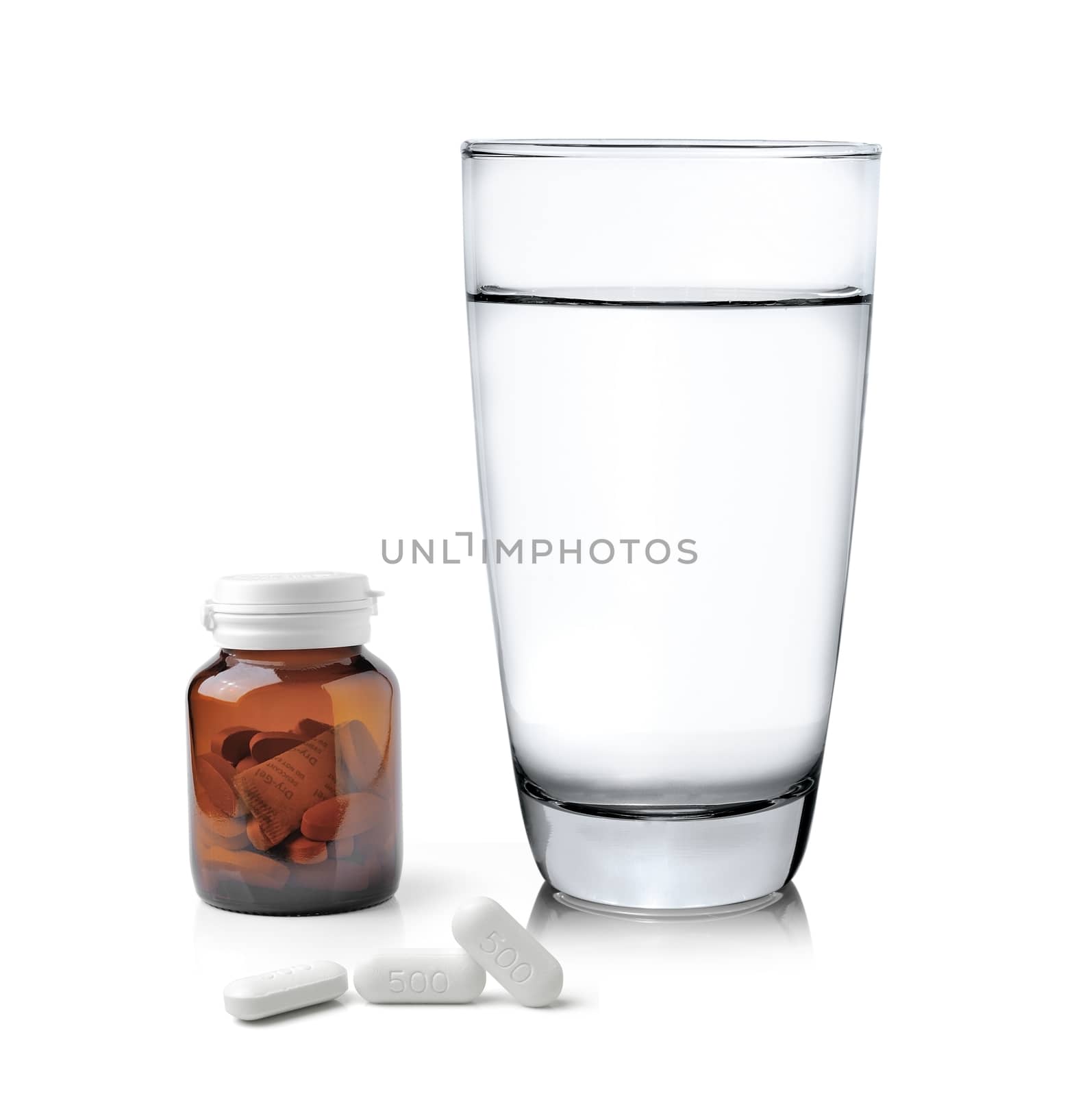 Glass of water Medicine bottle and pills isolated on white background