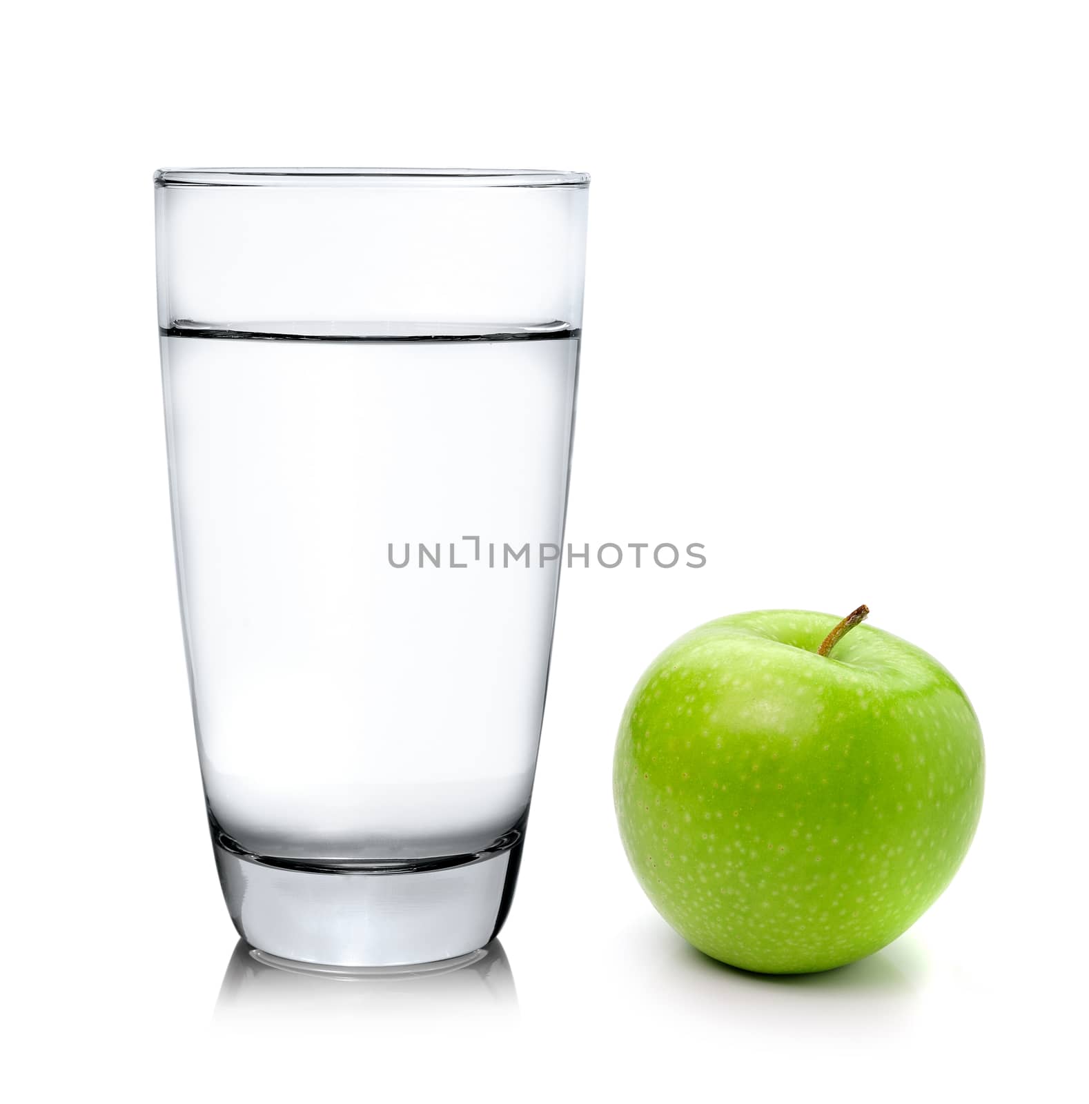 Green apple and pills capsules isolated on white background by sommai