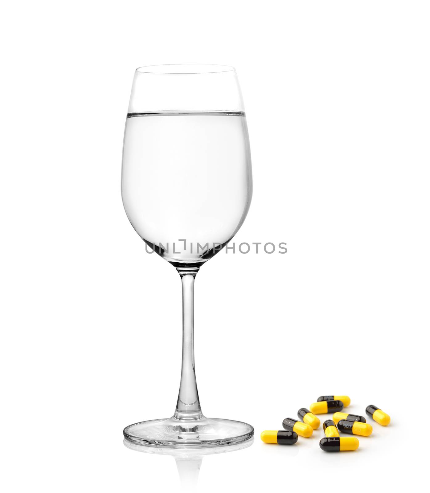 glass of water and pills capsules isolated on white background