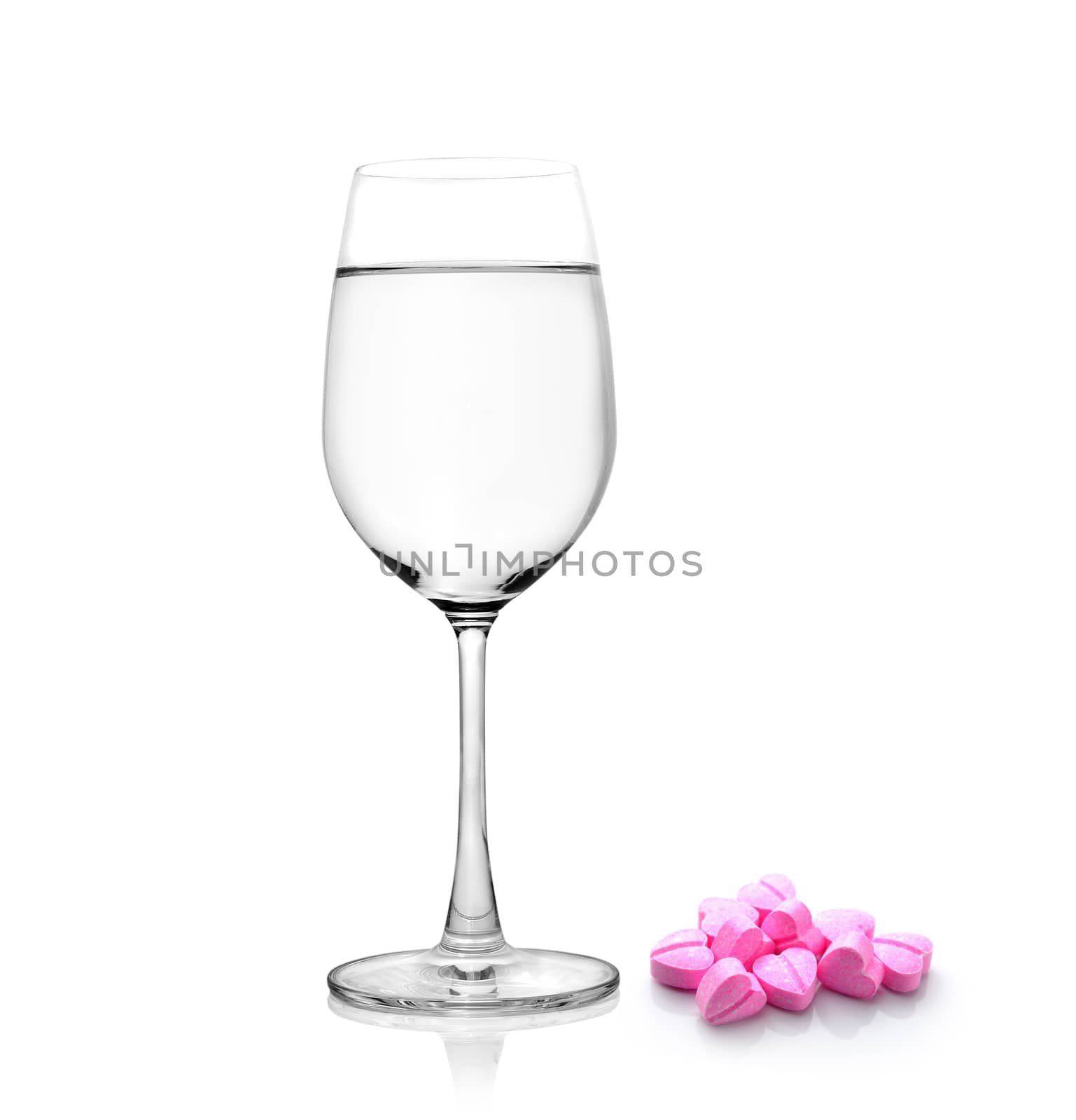 Glass of water and pills isolated on white background