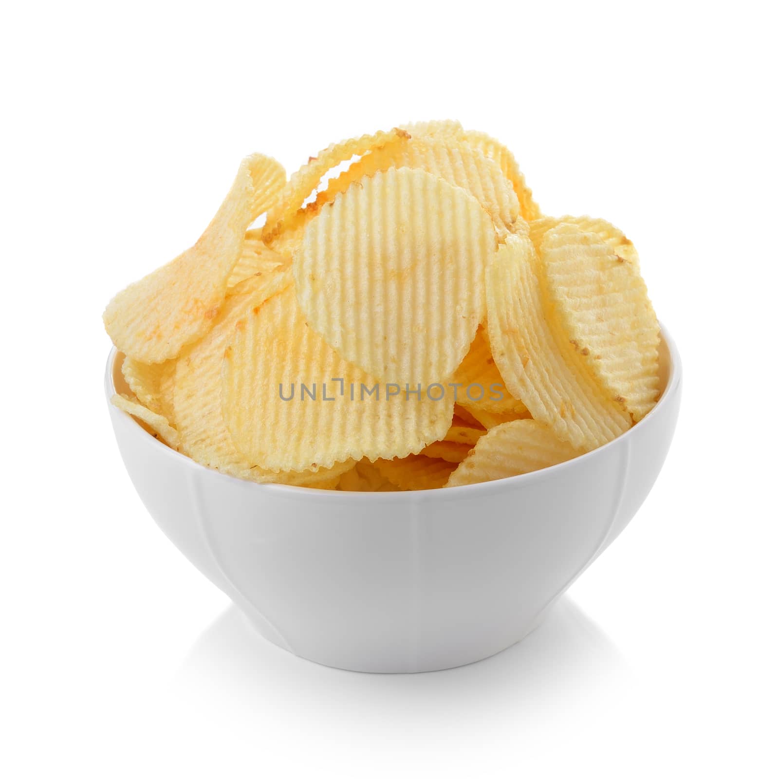 Bowl of potato chips on white background by sommai