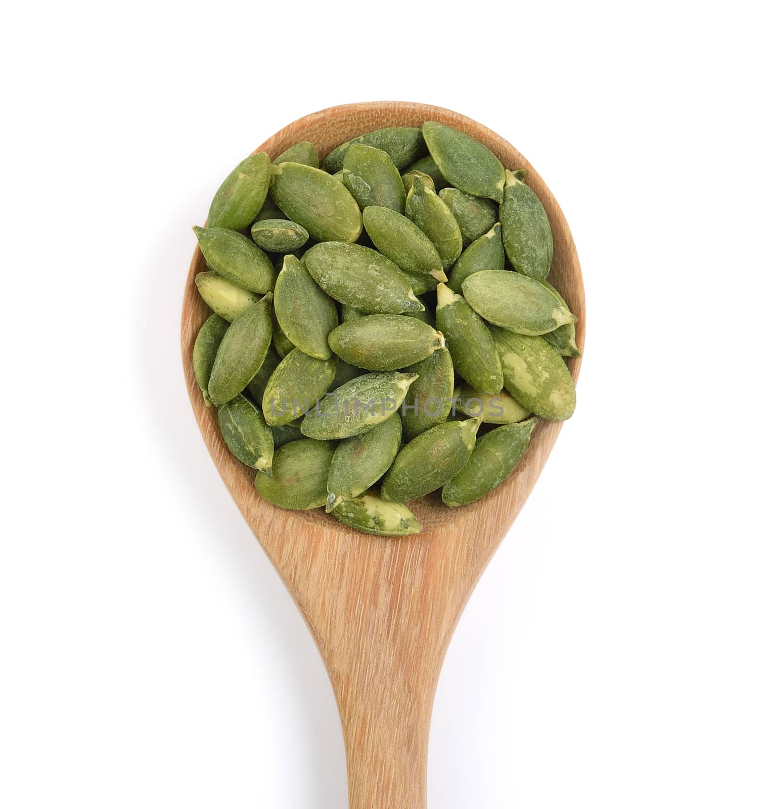 pumpkin seeds in the spoon on white background